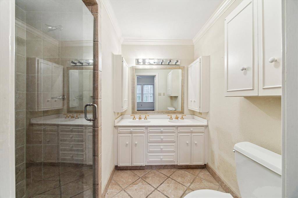 Private primary bath with large shower and double sinks.