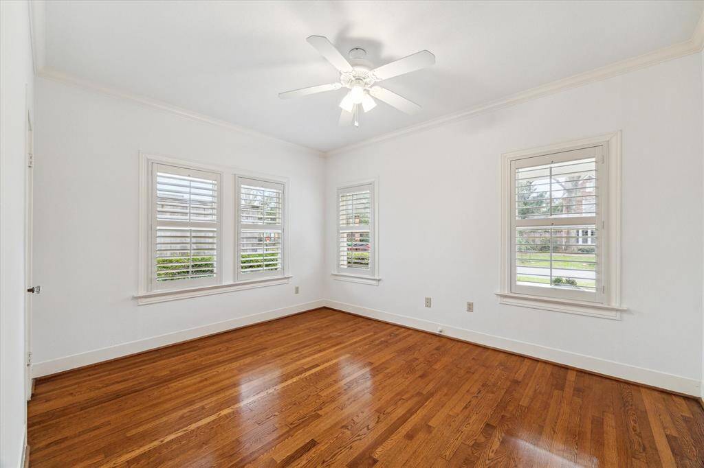One of two secondary bedrooms - both can accommodate a queen size bed and feature hardwoods and plantation shutters.