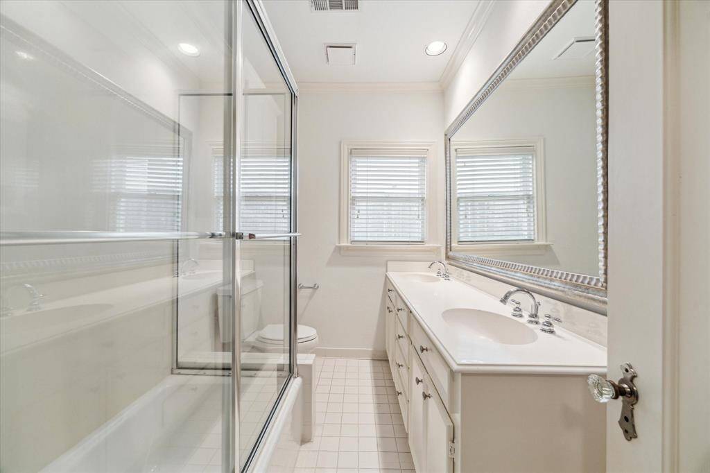Secondary bathroom conveniently located in the hall between the two secondary baths - double sinks and a large tub/shower.