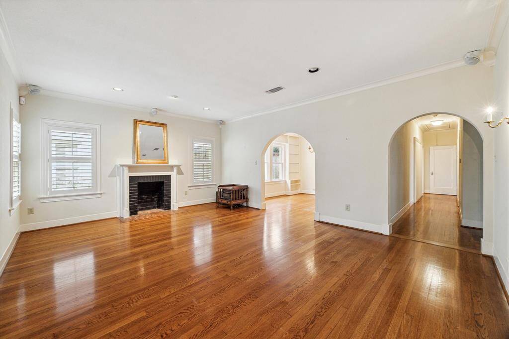Gleaming hardwoods, graceful archways, plantation shutters, and high ceilings welcome you in to this classic bungalow.