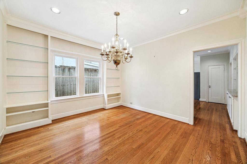 Dining room also features lovely and practical built in glass shelving.