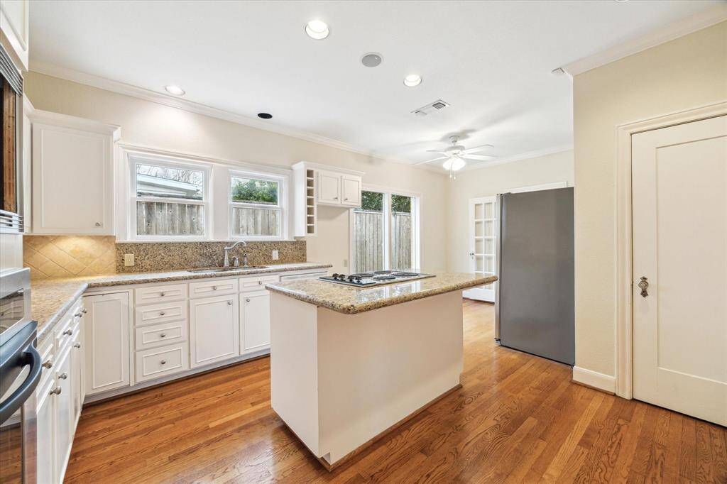 Kitchen includes hardwoods and granite counters.