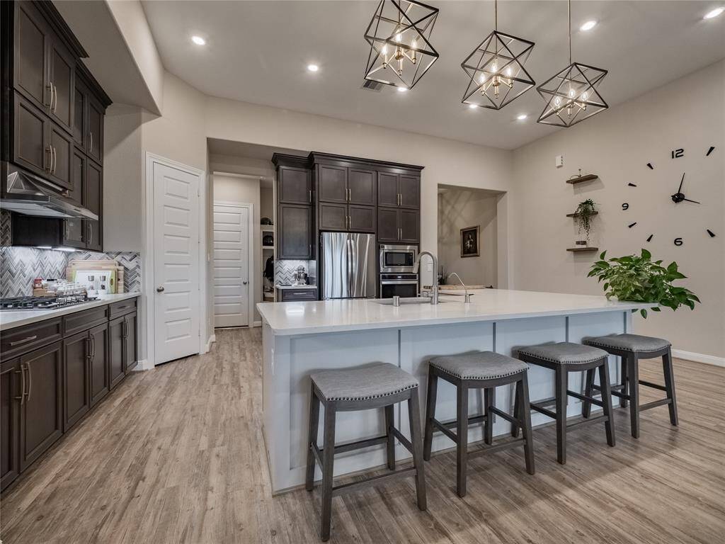 beautiful cabinets corner pantry and a drink station by the fridge fr om the kitchen you have an entrance to the small hallway with the mudd area and to garage
