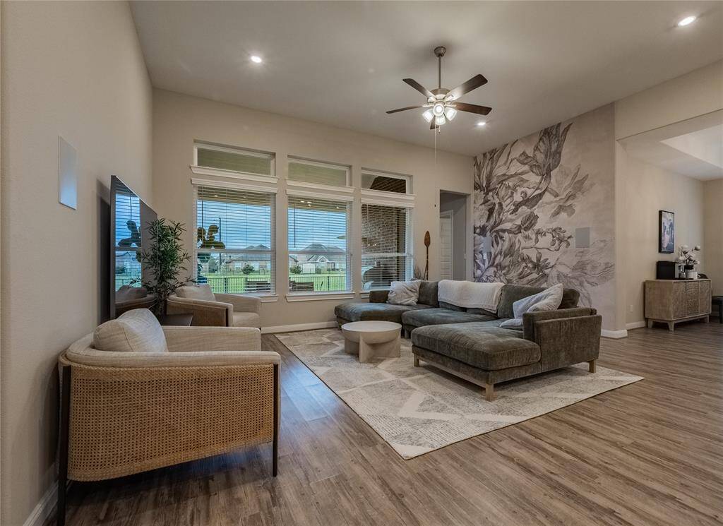 family room has recessed lighting, Bose wall speakers  and  oversized windows and a great view of the lake