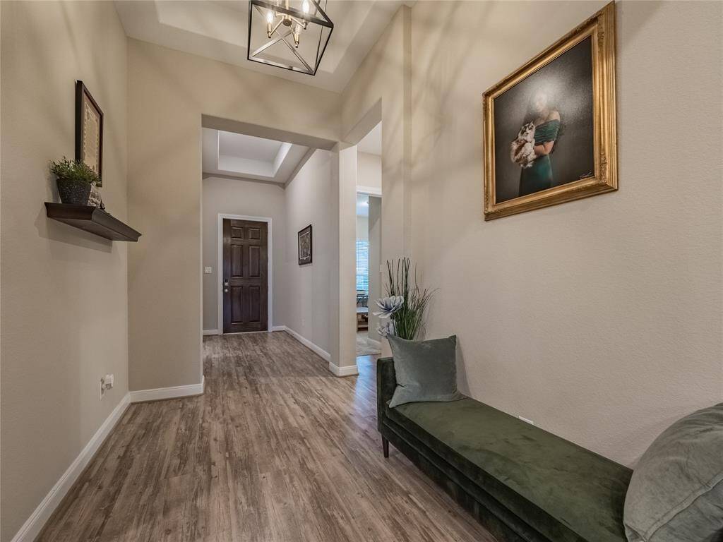 this view is the front door as you enter you will be over whelmed with the beautiful floors and modern lighting on you left you have 2 bedrooms and a bath on your right you have an office