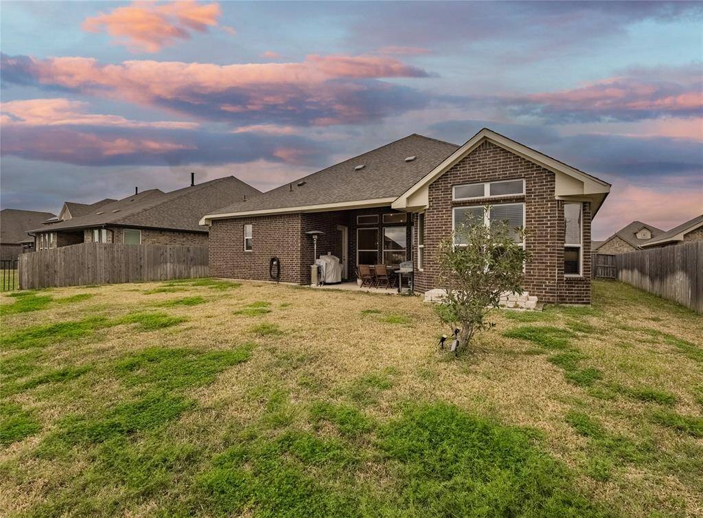 view of the back of this all brick single story home, just waiting for the new owner