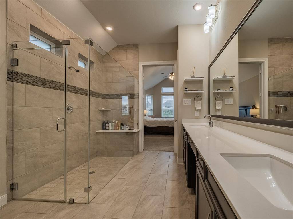 primary bath has an oversized sunken shower all glass