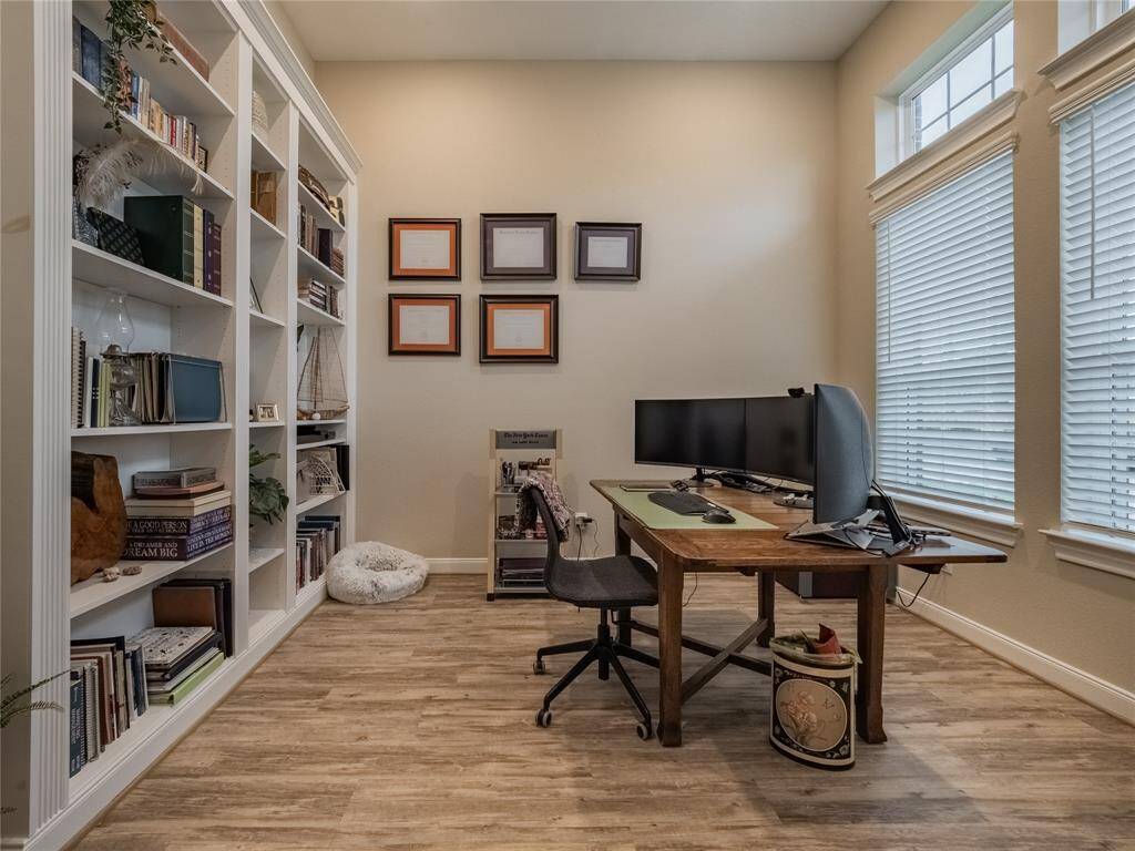 the office has double oversized windows that lets a lot of natural light in and faces the road
