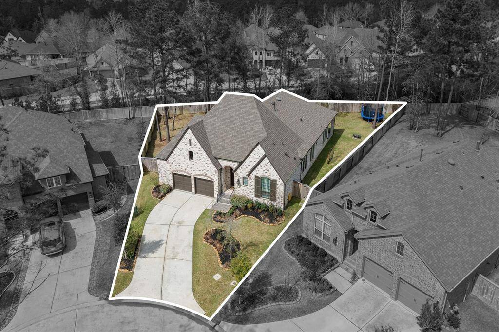 This home features a charming brick exterior with a two &1/2 car garage and a spacious driveway. It's situated on a uniquely shaped lot in a wooded neighborhood, offering privacy and a well-maintained lawn. Ideal for families seeking a serene residential setting.