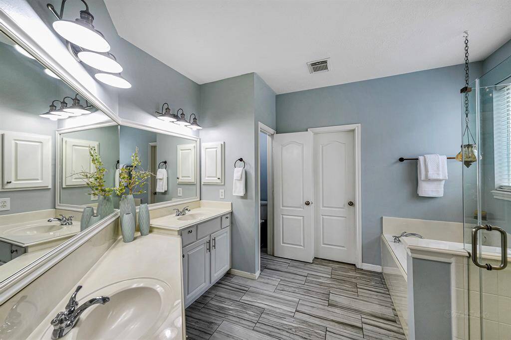 Luxurious ensuite bath with double sinks, soaking tub and walk-in shower
