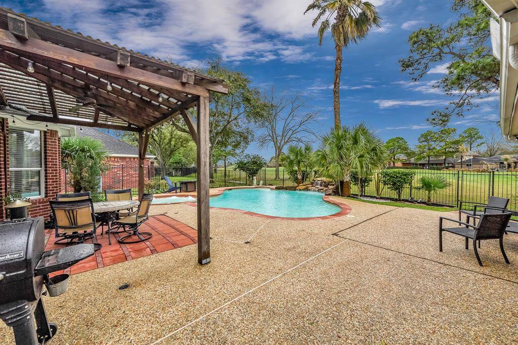 Lush landscaping surrounds the back yard