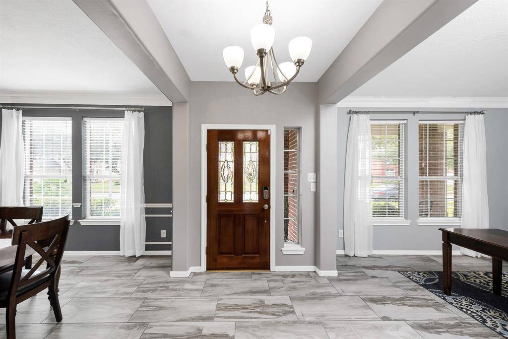 Beautiful entryway with decorative glass insets in the front door
