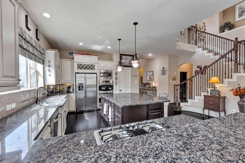 This kitchen offer two bar seating areas.  One at counter height off the island and this one at bar height above the gas stove.