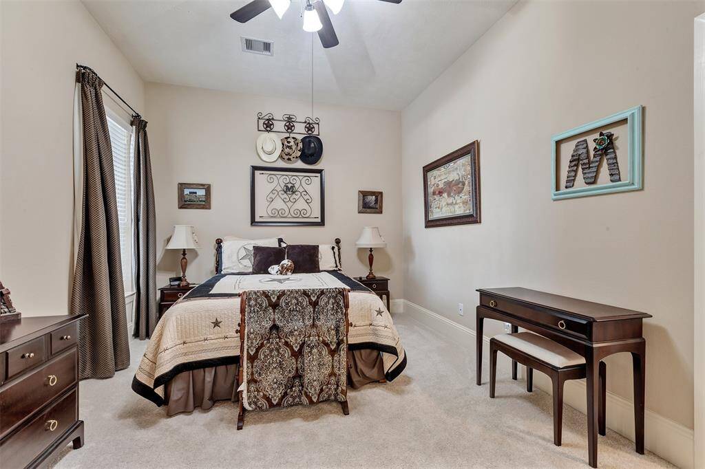 Here is the secondary  bedroom with a ensuite bath located downstairs, tucked away in a hallway for privacy.
