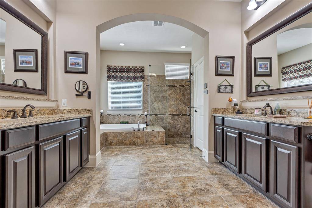 The primary bathroom offers dual vanities, seperate tub and shower, and plenty of room for everyone