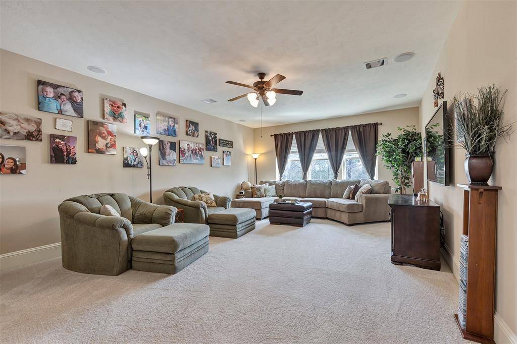 The media/game room is surround sound ready. It offers a shelfed closet for storing games and other items. Access to one of the walk in attics is here as well.
