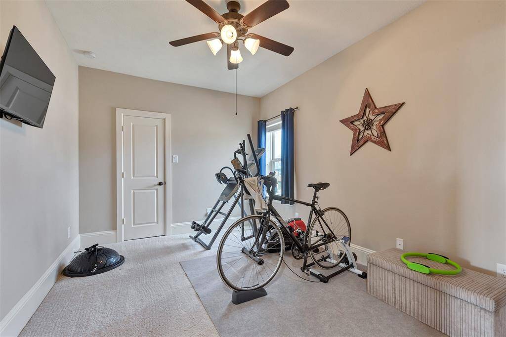 This bedroom is being used as an exercise space. It shares a bath with another bedroom.