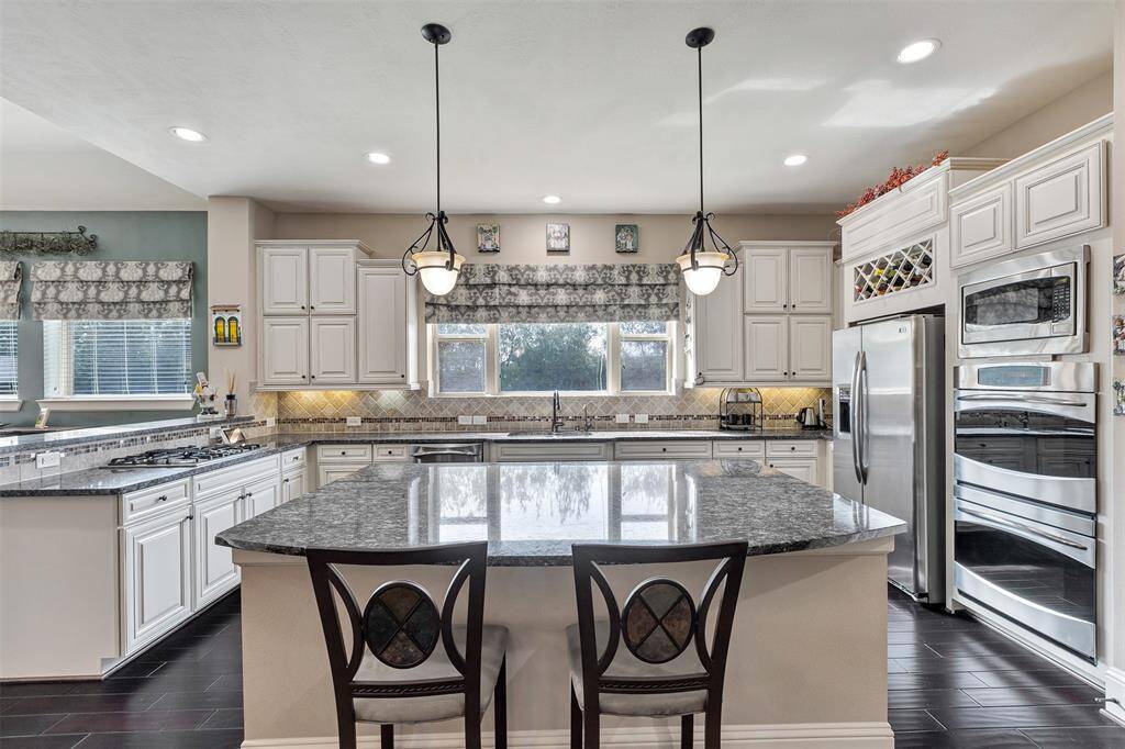 This dream kitchen is the heart of this fabulous home. Spacious counter tops and massive island makes cooking a dream