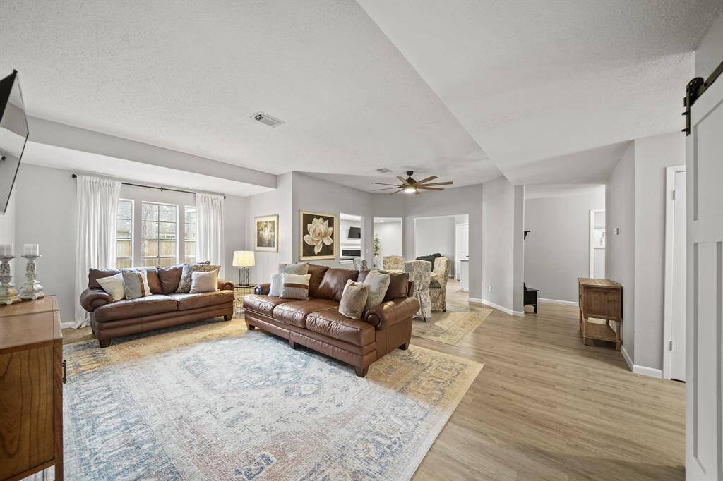 A view of the formals with the family room & secondary bedroom corridor in the background.