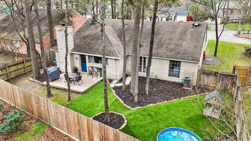 An aerial view of the home, fence lines & backyard.