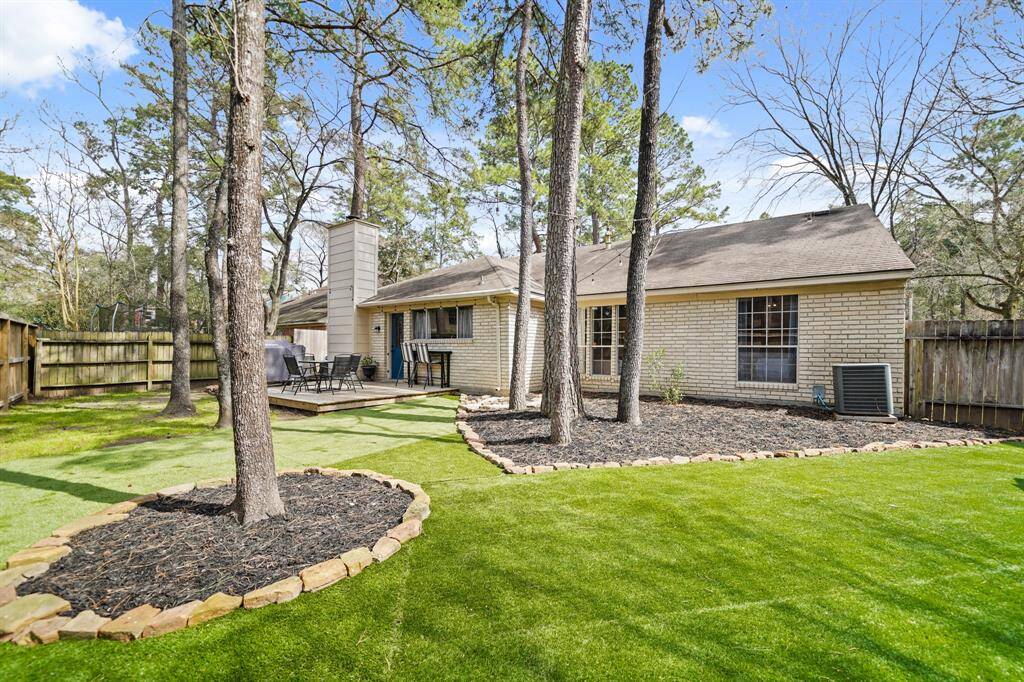 A view of the back of the home and backyard. The fence was replaced in 2023.