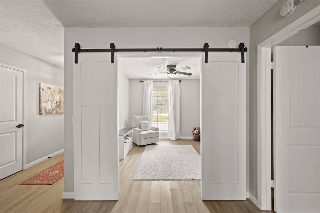 Just off the formal living room and tucked away behind beautiful sliding barn doors is a private study.