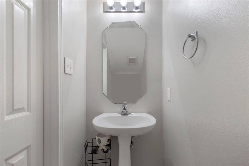 Convenient half bath located on the first floor for easy access by guests.