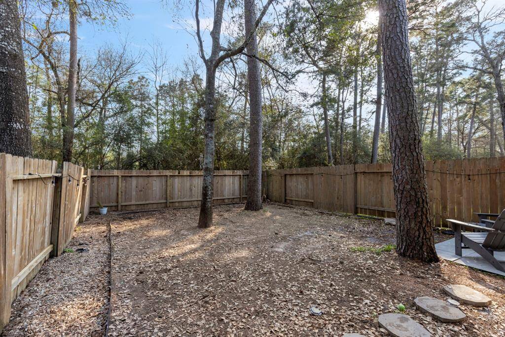 A spacious backyard with endless possibilities, perfect for creating your own outdoor oasis, gardening, or entertaining guests.