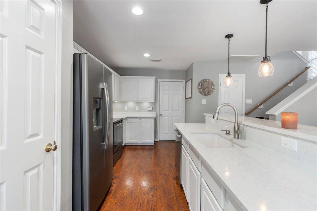The kitchen boasts a pantry, stylish pendant lighting, and convenient under-cabinet lighting, adding both function and charm.