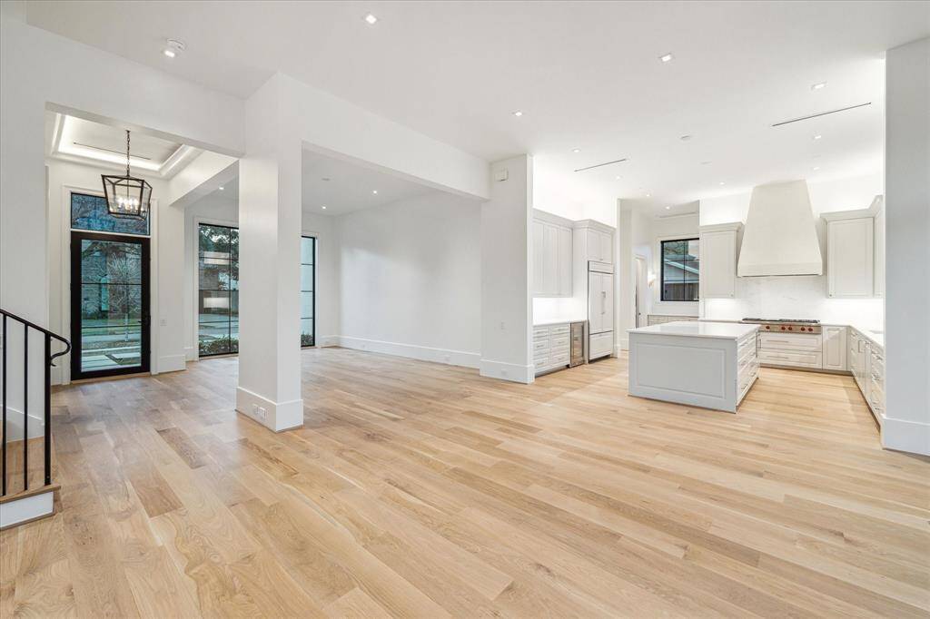 [Kitchen]The kitchen offers job-built cabinetry; an island with breakfast shelf; rich marble countertops and backsplashes; professional-grade Wolf 6-burner cooktop with Venetian plaster hood; SubZero cabinet-front refrigerator/freezer; Allia Paris fireclay sink; and a Zephyr wine chiller.
