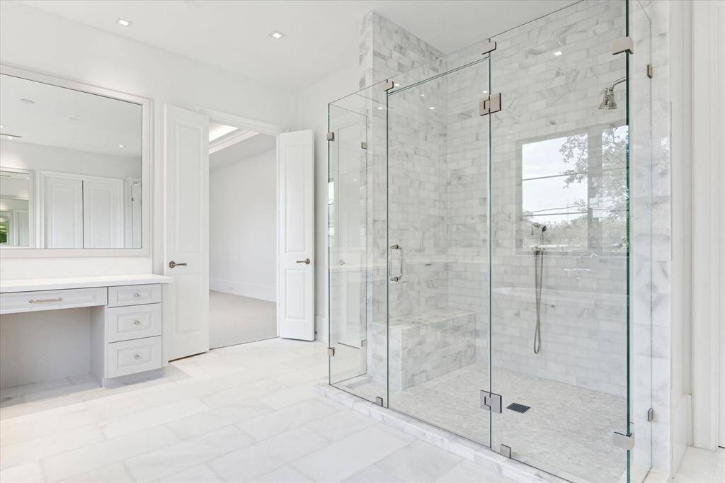 [Primary Bath]This view reveals the entrance into the double, custom-fitted closet.