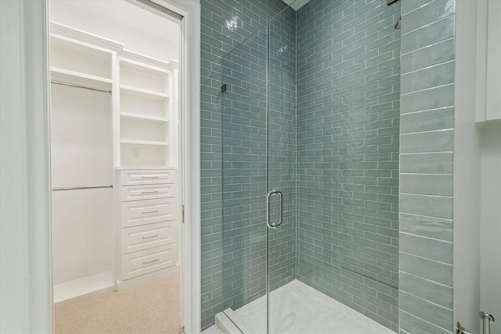 [Secondary Bedroom En Suite Bath]This view reveals this bedroom's custom closet.