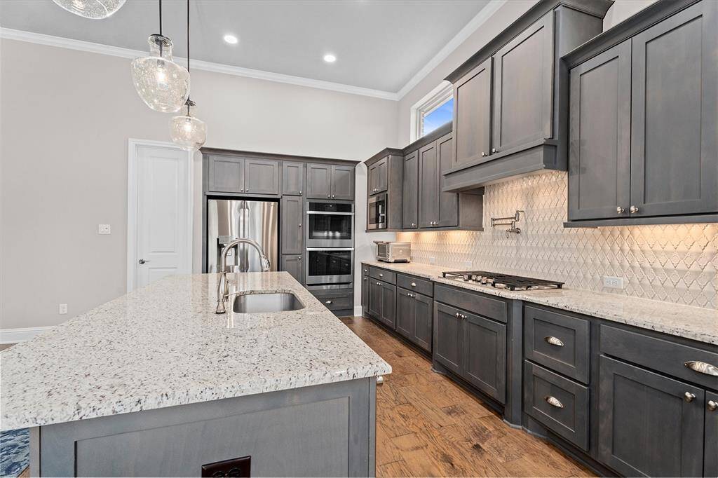 Gas cooktop, smart double oven and pot filler for ease and convenience in this beautiful  Chef's kitchen.