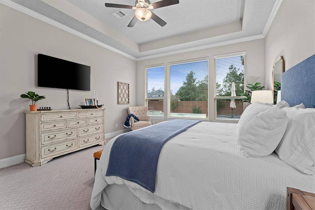 Primary bedroom located on main floor also enjoys amazing views of gorgeous back yard oasis.