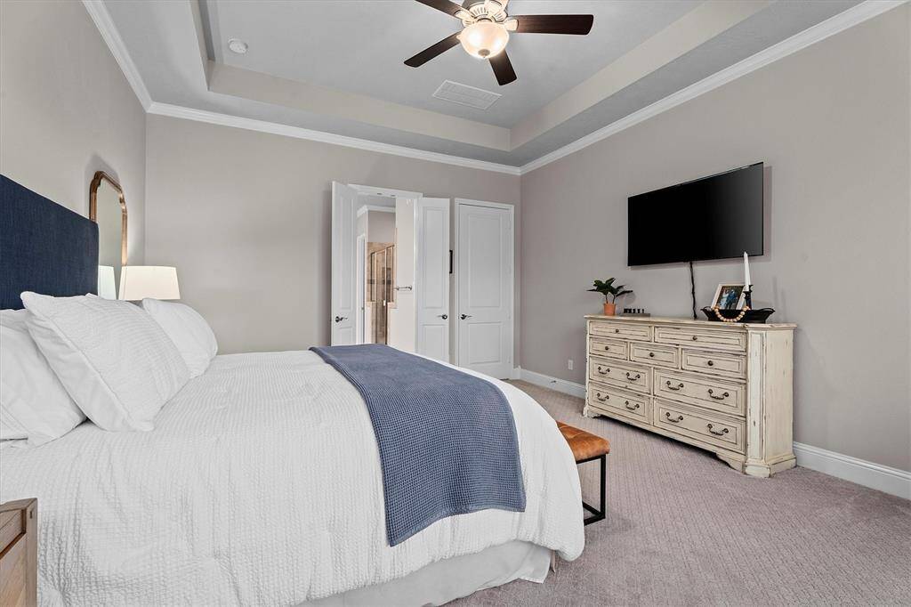 This incredible utility room has built in bench with hooks and storage as well as a huge storage area behind washer and dryer.