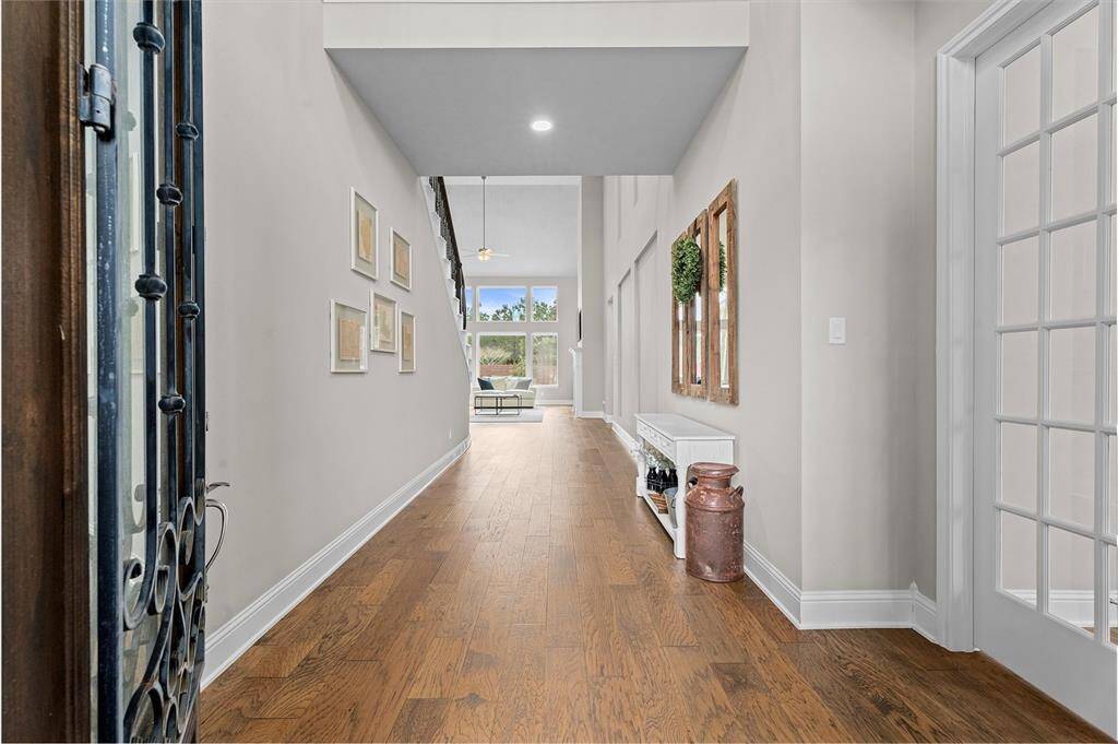 As soon as you enter, you notice extra wide entry with beautiful hard wood floors flowing into the home.
