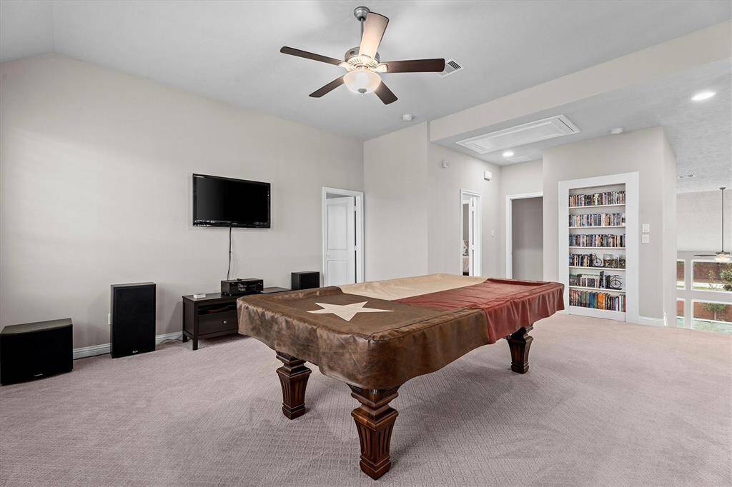 Another view of game room shows front of secret room and ledge overlooking main floor.