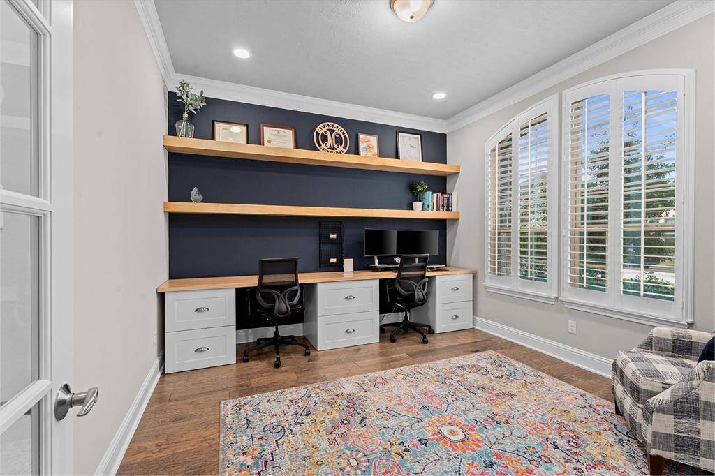 To the right of the entrance is this private and spacious home study complete with built in storage and shelving.