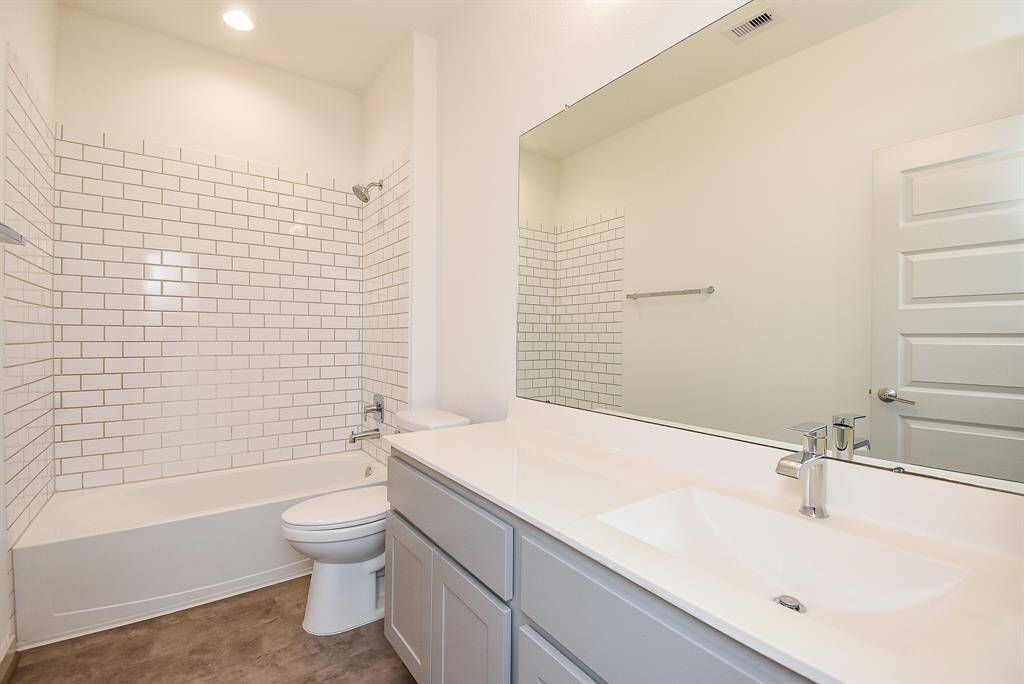 A full secondary bathroom offers all the creature comforts of the primary.