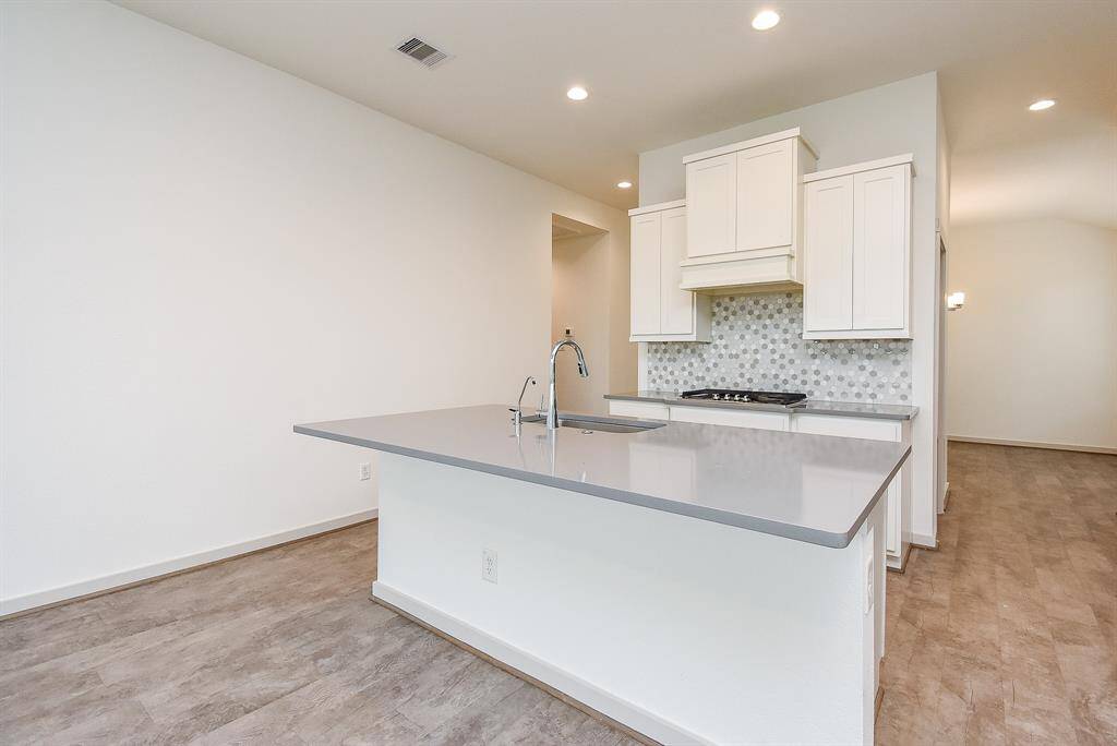 Easy traveling and tasking are guaranteed in this open kitchen!