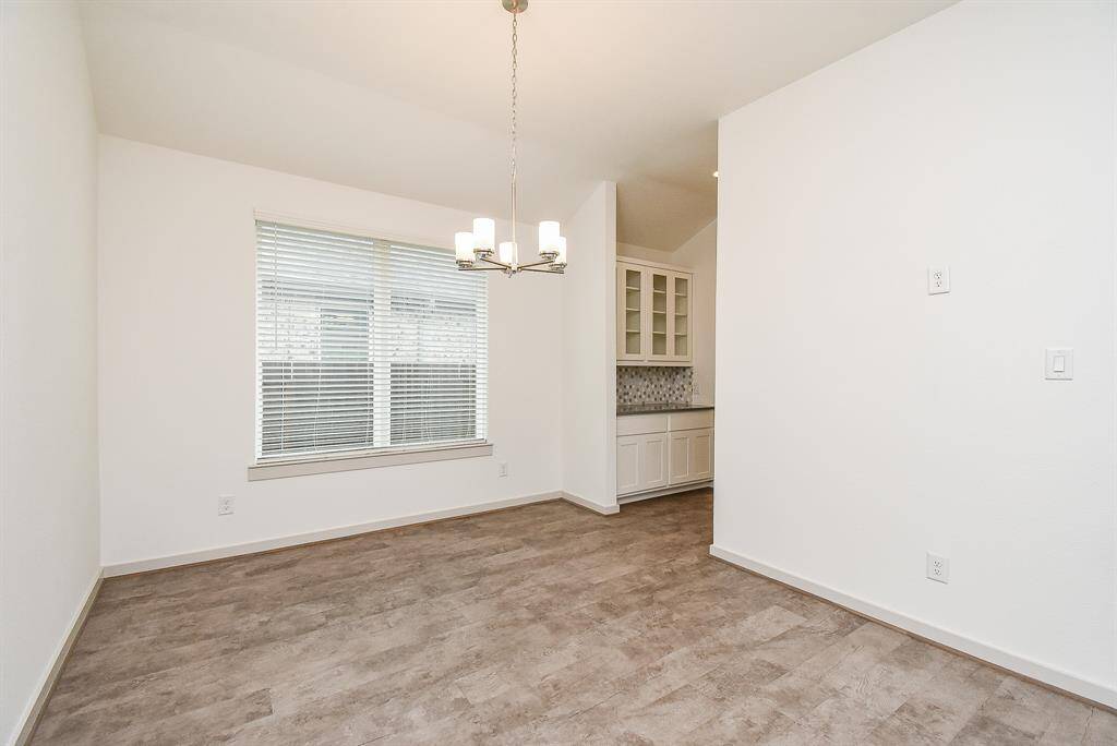 Double windows bring lots of natural light into the spacious formal dining area, with the kitchen directly right.