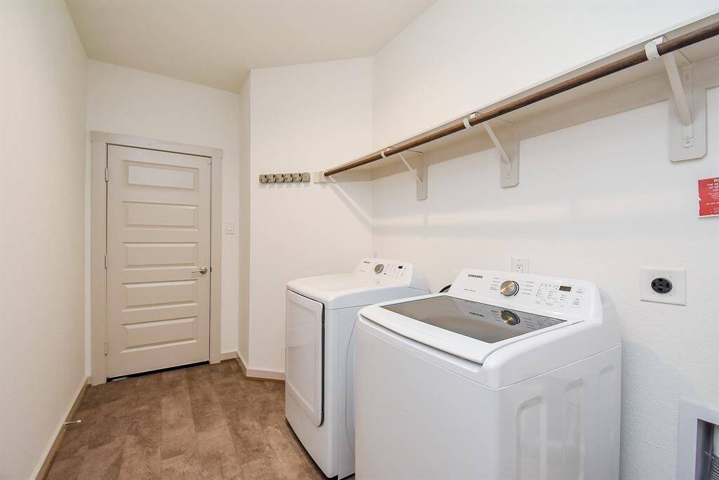 Even the neat and tidy utility room easily accommodates dual laundry appliances, with welcomed storage above.
