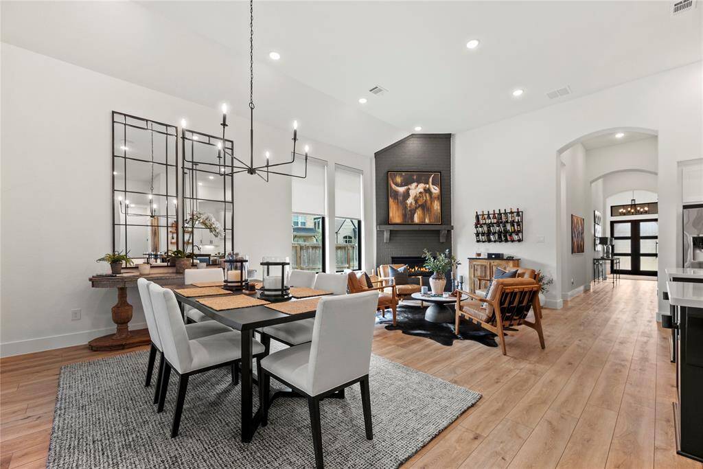 The luxury fixture adds to the upscale atmosphere, with a dazzling chandelier casting a soft, flattering light over the space.