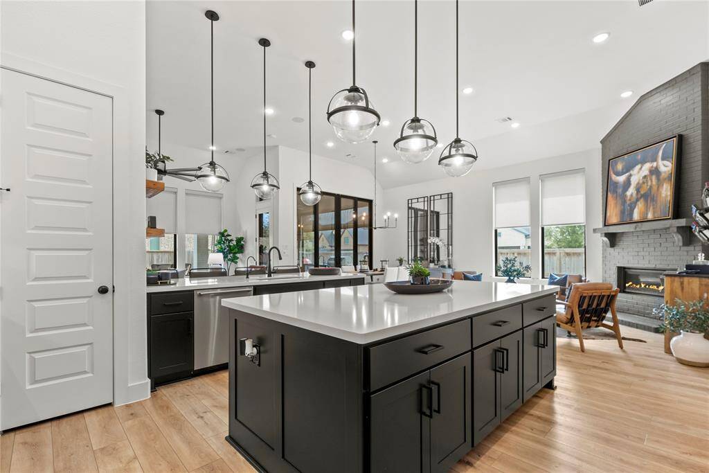 The sprawling center island serves as a versatile centerpiece, providing additional workspace and storage.