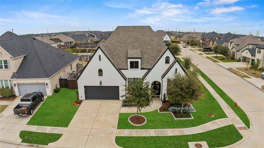 This stunning aerial view highlights this impressive corner lot location, perfectly situated for both privacy and convenience.