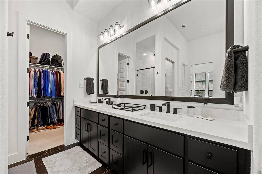 The primary bathroom is private and inviting, roomy enough to move around comfortably.