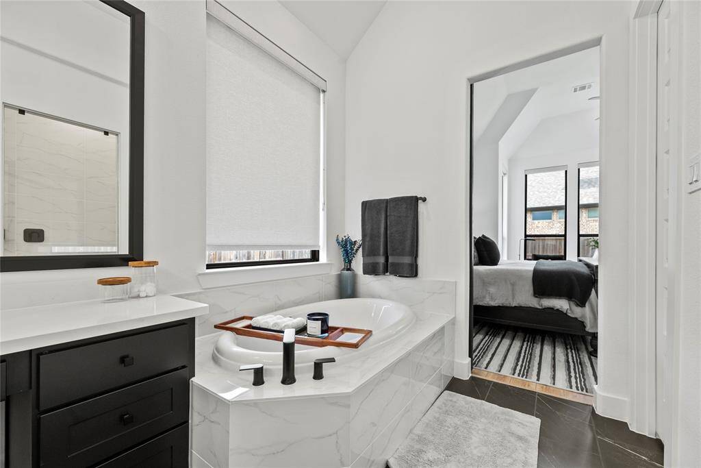 The soaking tub is a perfect space to sink in and relax.