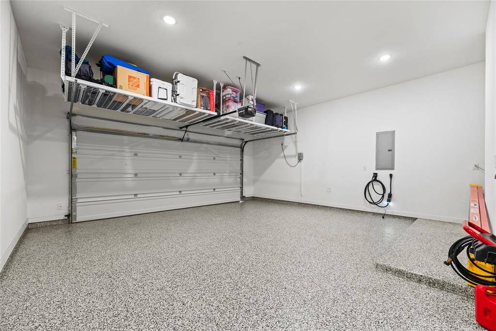 The immaculately maintained garage features durable epoxy flooring, offering a sleek, polished look with easy maintenance.