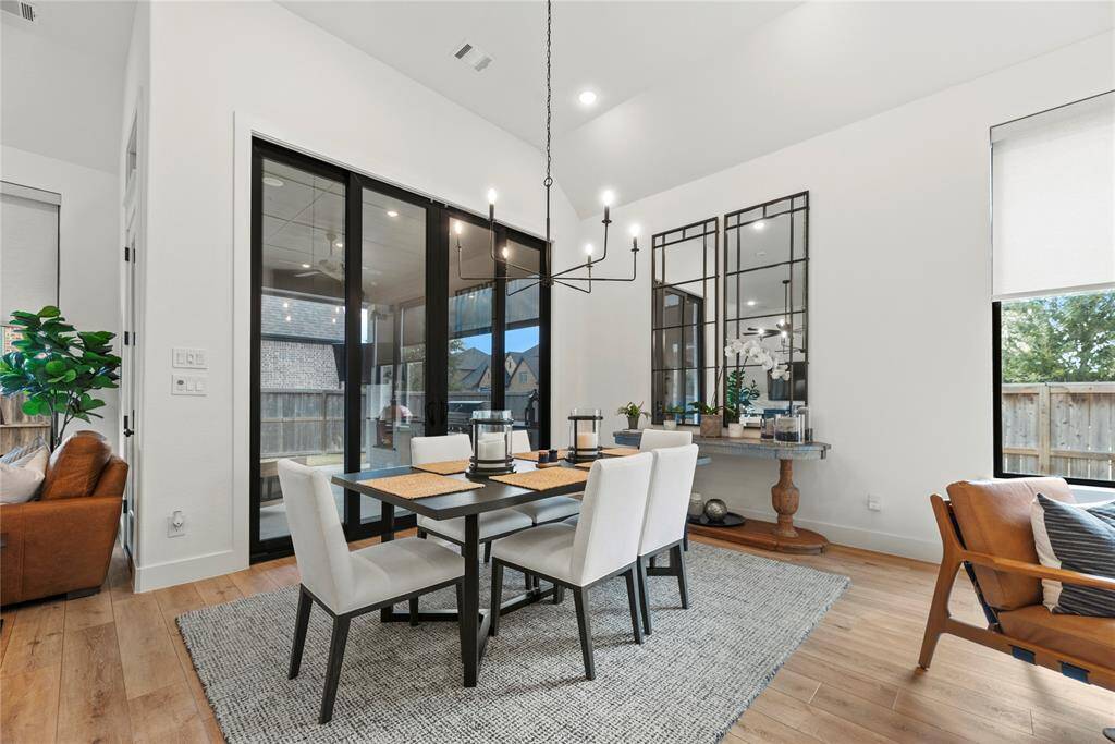This spacious dining room is perfect for entertaining and will accommodate a large table.  Beautiful ceiling lines with wood flooring create the perfect setting for those special meals.
