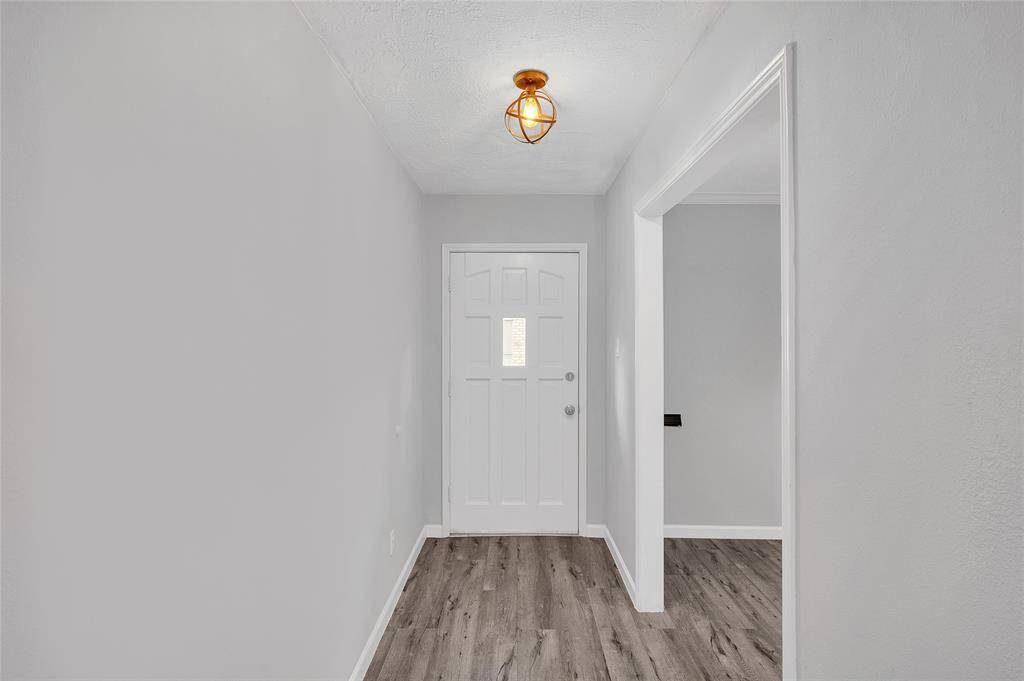 Entry way features recent lighting.